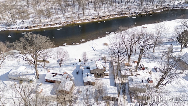 snowy aerial view featuring a water view