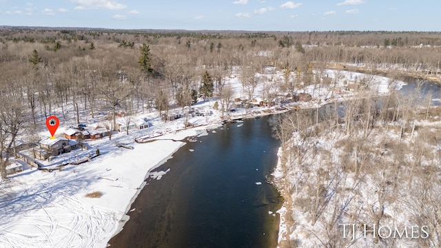 snowy aerial view with a water view