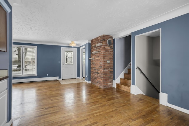 interior space with a baseboard radiator, a textured ceiling, and hardwood / wood-style flooring