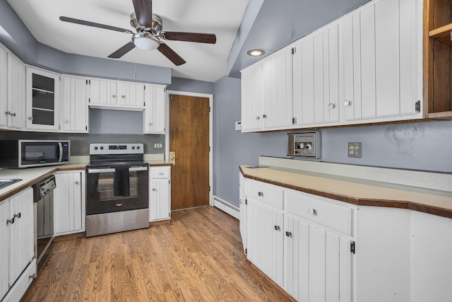 kitchen featuring baseboard heating, light hardwood / wood-style floors, stainless steel appliances, ceiling fan, and white cabinetry