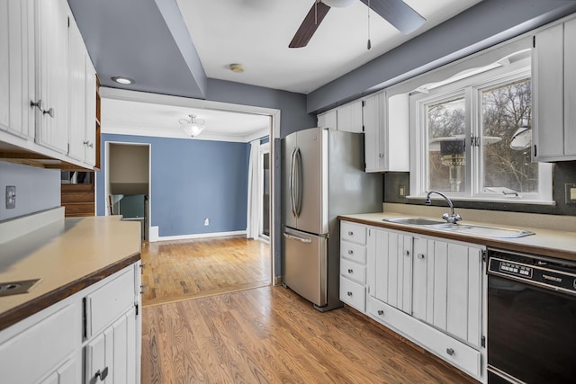 kitchen featuring white cabinetry, dishwasher, and stainless steel refrigerator