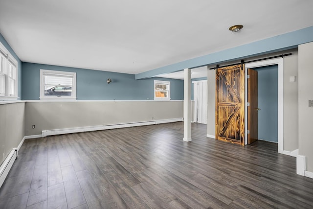 unfurnished bedroom with a barn door, a baseboard radiator, and dark hardwood / wood-style flooring