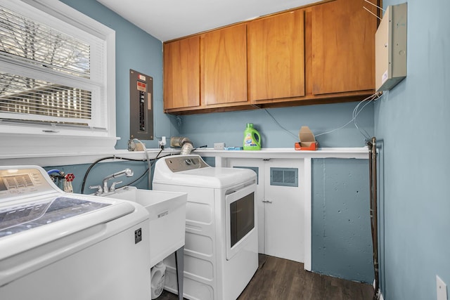 laundry area featuring separate washer and dryer, cabinets, and dark hardwood / wood-style floors