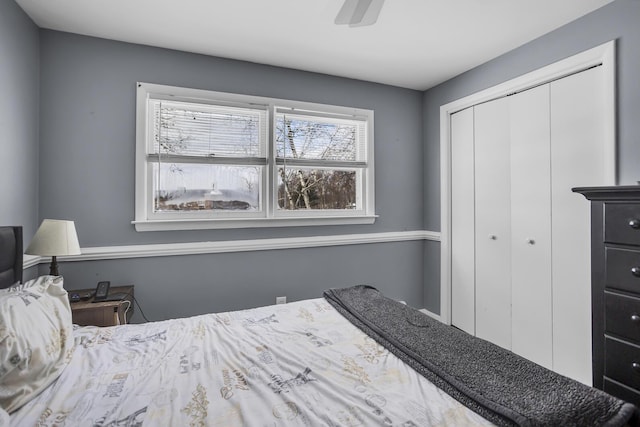 bedroom featuring ceiling fan, a closet, and multiple windows