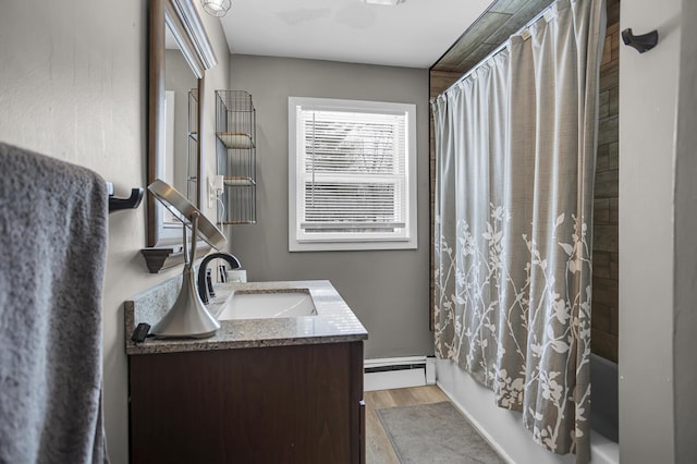 bathroom with hardwood / wood-style floors, a baseboard radiator, shower / bath combination with curtain, and vanity