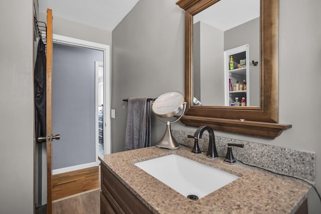 bathroom with vanity and hardwood / wood-style floors