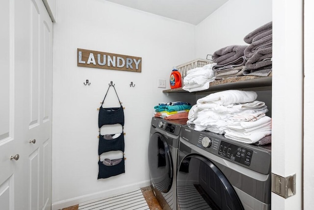 clothes washing area featuring separate washer and dryer