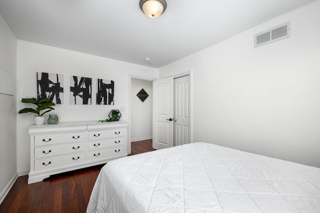 bedroom featuring hardwood / wood-style floors and a closet