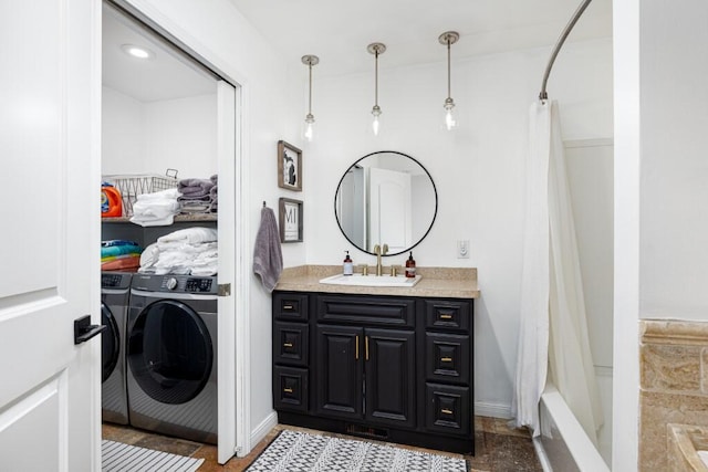 bathroom with shower / tub combo with curtain, vanity, and washing machine and clothes dryer