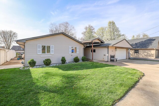 ranch-style house featuring a garage, a front lawn, fence, and concrete driveway