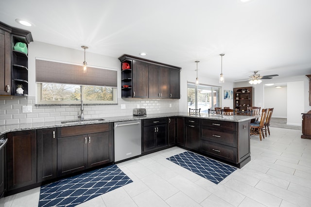 kitchen featuring pendant lighting, sink, dishwasher, tasteful backsplash, and kitchen peninsula