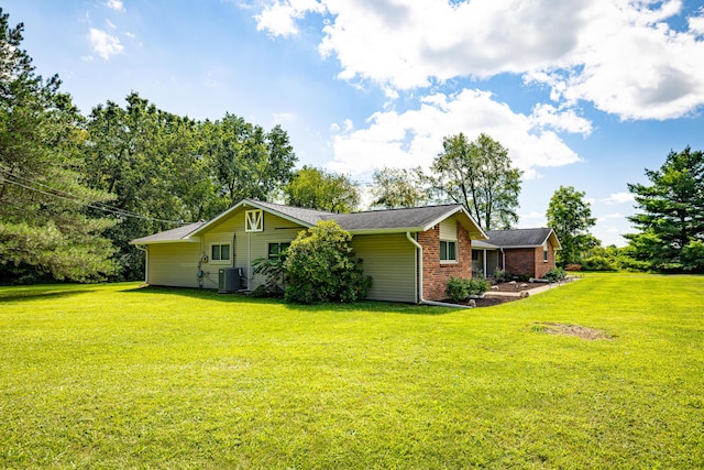 view of property exterior featuring cooling unit and a yard