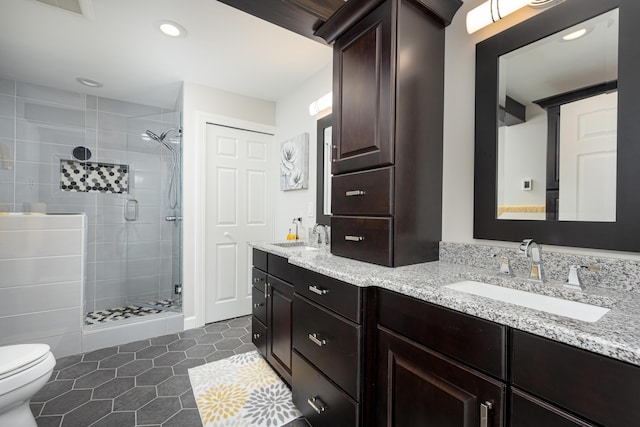 bathroom with vanity, tile patterned flooring, a shower with door, and toilet