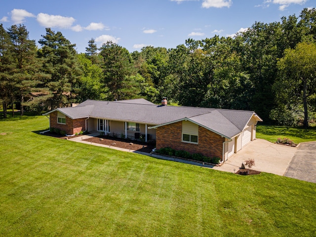 ranch-style home featuring a garage and a front yard