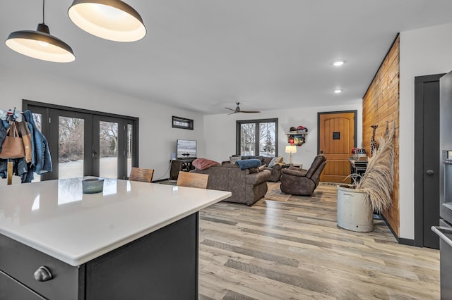 kitchen featuring french doors, ceiling fan, light hardwood / wood-style floors, and pendant lighting