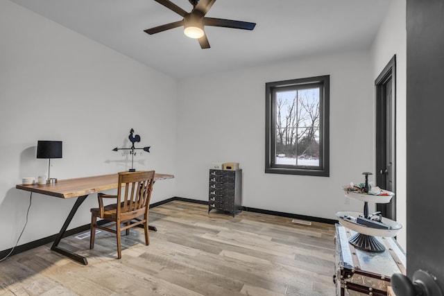 office area with light hardwood / wood-style floors and ceiling fan