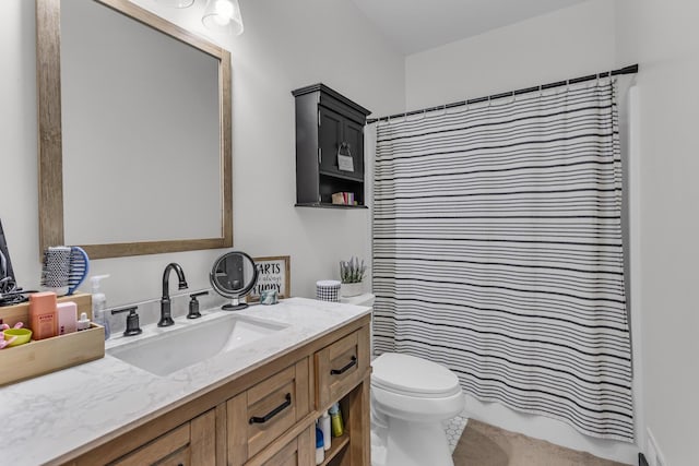 bathroom with vanity, toilet, and curtained shower