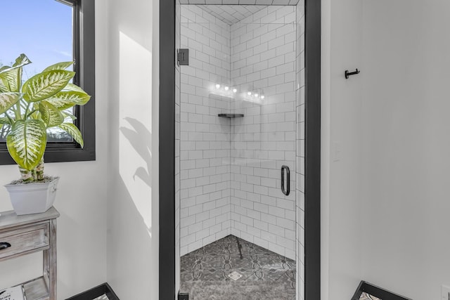 bathroom featuring a shower with door