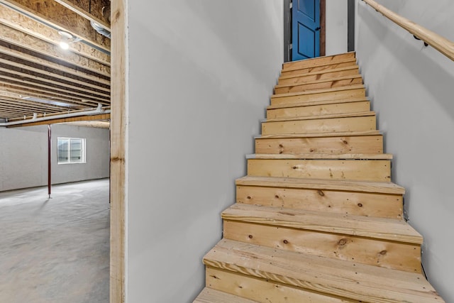 staircase featuring concrete floors