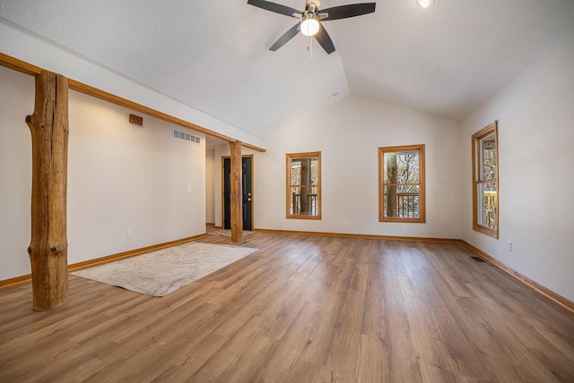 unfurnished living room featuring ceiling fan, wood-type flooring, and vaulted ceiling