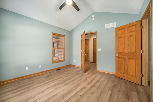 unfurnished bedroom with ceiling fan, lofted ceiling, and light hardwood / wood-style floors