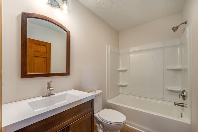 full bathroom with shower / tub combination, vanity, a textured ceiling, and toilet