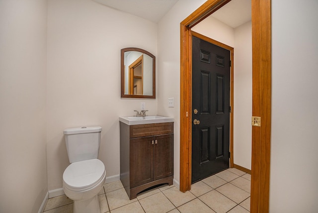 bathroom featuring vanity, tile patterned floors, and toilet