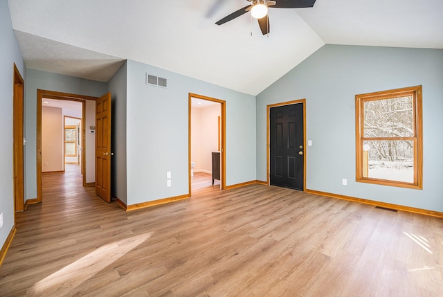 unfurnished bedroom with light hardwood / wood-style flooring, ceiling fan, and vaulted ceiling