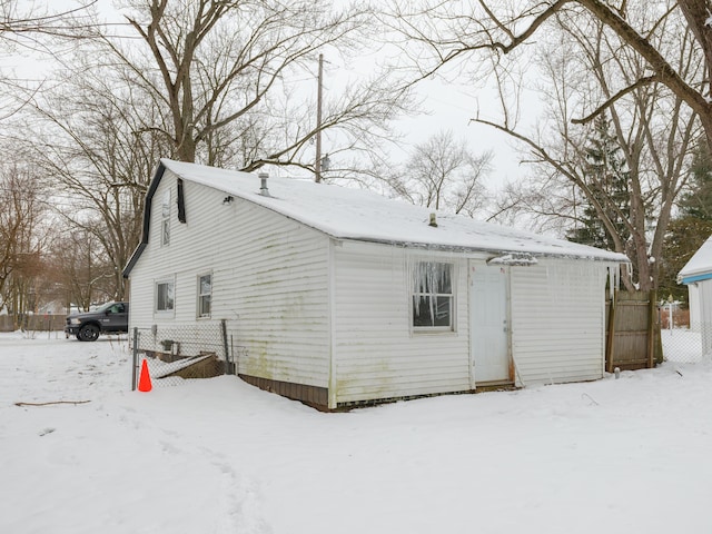 view of snow covered rear of property