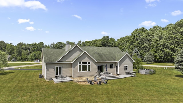 rear view of property with a patio, a yard, and central air condition unit