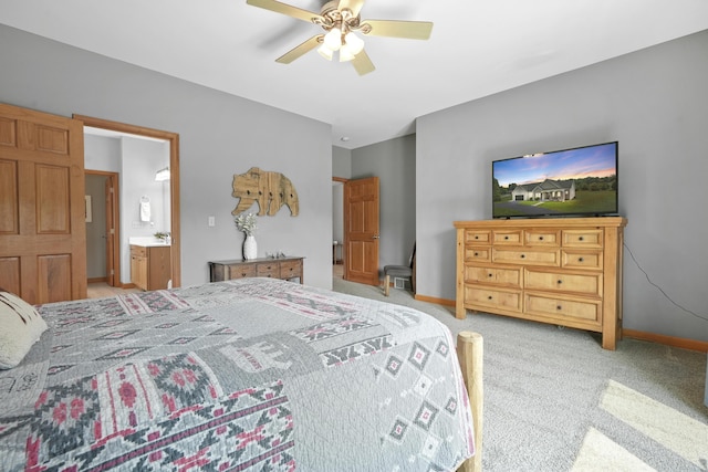 carpeted bedroom featuring ceiling fan and ensuite bath