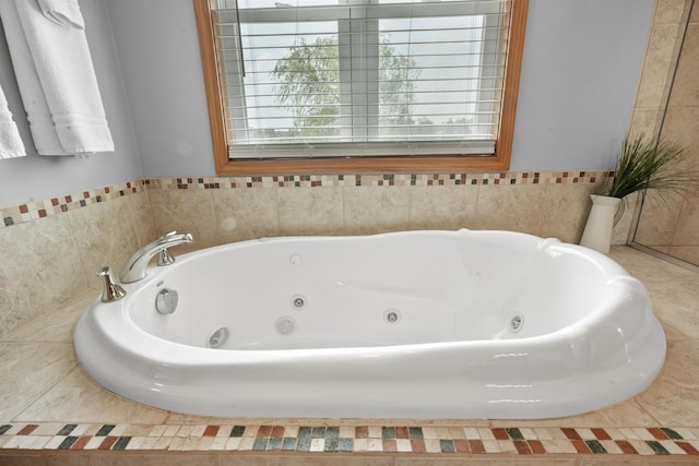 bathroom featuring a relaxing tiled tub