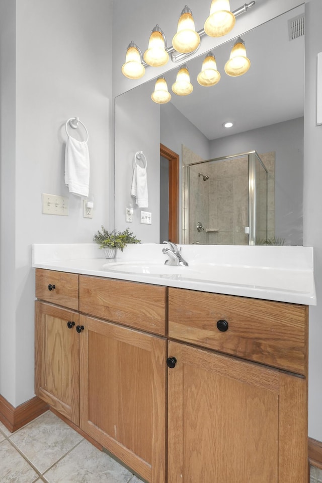 bathroom with vanity, an enclosed shower, and tile patterned floors