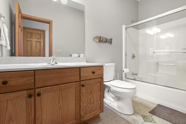 full bathroom featuring toilet, tile patterned flooring, vanity, and shower / bath combination with glass door