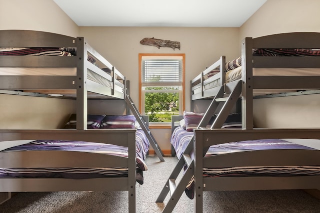 bedroom featuring lofted ceiling and carpet