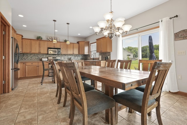 tiled dining space with sink and an inviting chandelier