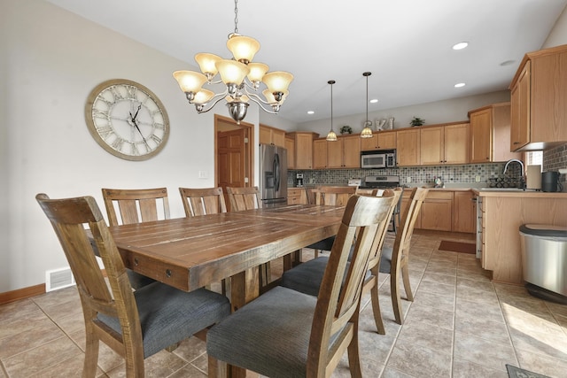 tiled dining room featuring a notable chandelier