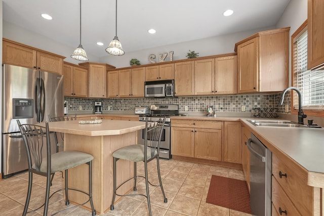 kitchen featuring a center island, hanging light fixtures, stainless steel appliances, light tile patterned floors, and sink