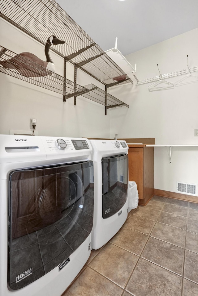 laundry room with washer and dryer and tile patterned floors