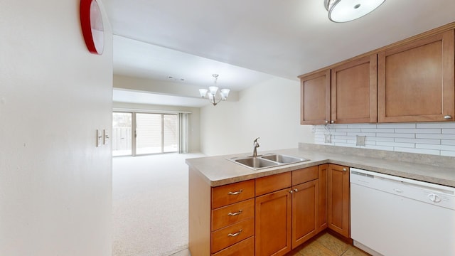 kitchen featuring kitchen peninsula, decorative backsplash, white dishwasher, light carpet, and sink