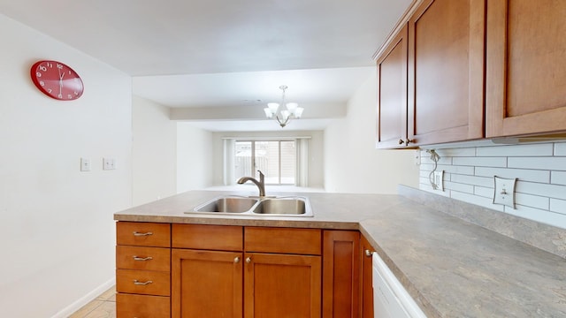 kitchen with kitchen peninsula, a notable chandelier, light tile patterned floors, backsplash, and sink