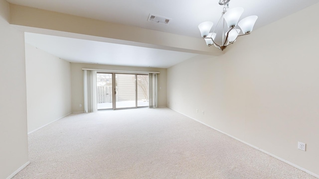 spare room featuring beam ceiling, light colored carpet, and an inviting chandelier