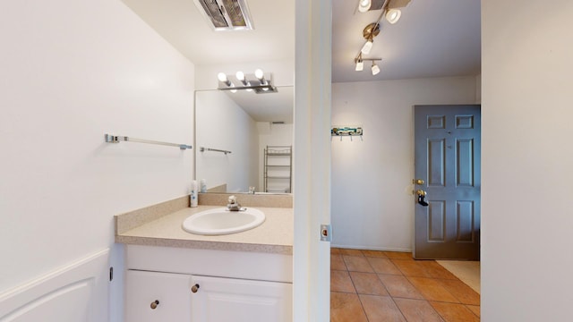 bathroom with tile patterned floors and vanity