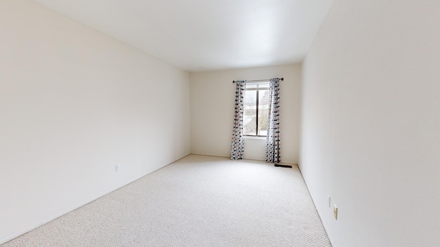 empty room with light colored carpet