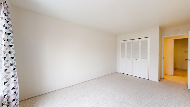 unfurnished bedroom with a closet and carpet