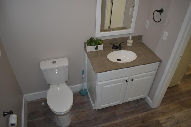 bathroom featuring hardwood / wood-style floors, toilet, and vanity