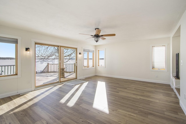 spare room with ceiling fan and dark hardwood / wood-style flooring