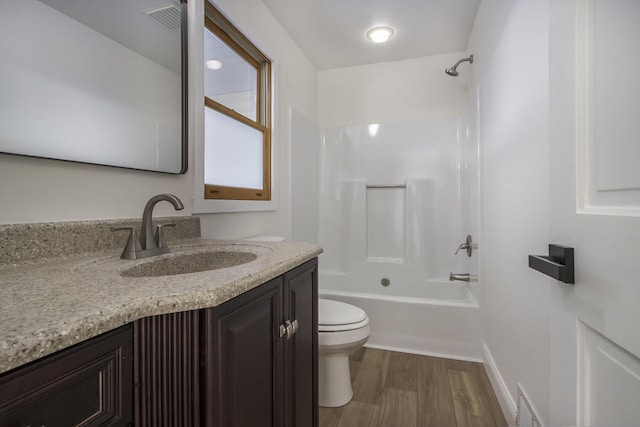 full bathroom featuring toilet, shower / bathtub combination, hardwood / wood-style flooring, and vanity