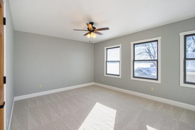 unfurnished room featuring ceiling fan and light colored carpet