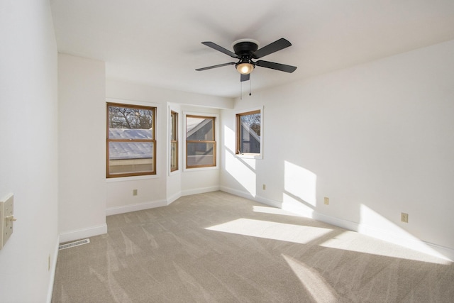 carpeted spare room with ceiling fan